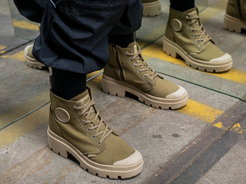 A demo of a green canvas boot from Palladium with tan accents.